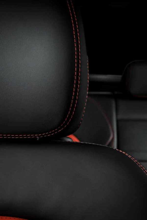 Modern race car  black and red perforated leather interior. Part of  leather car seat details.